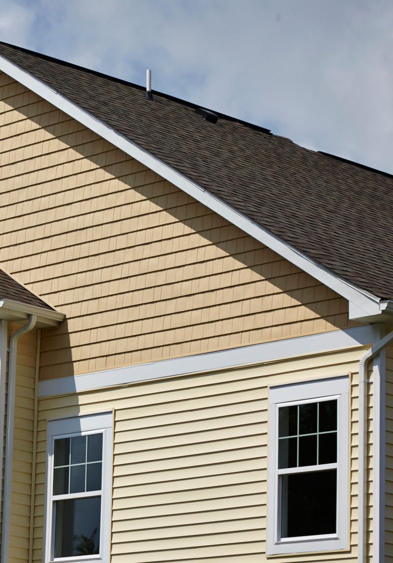 Tan house with shingle roof and siding