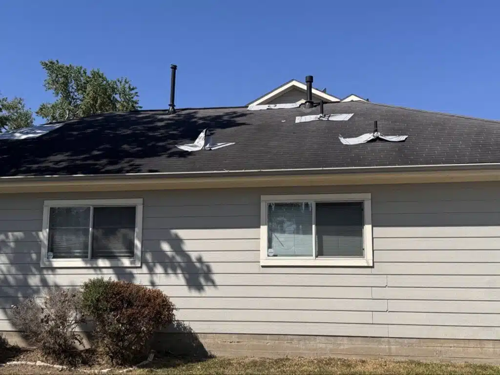 Hurricane Beryl roof damage covered with temporary underlayment patches in Sienna, Missouri City
